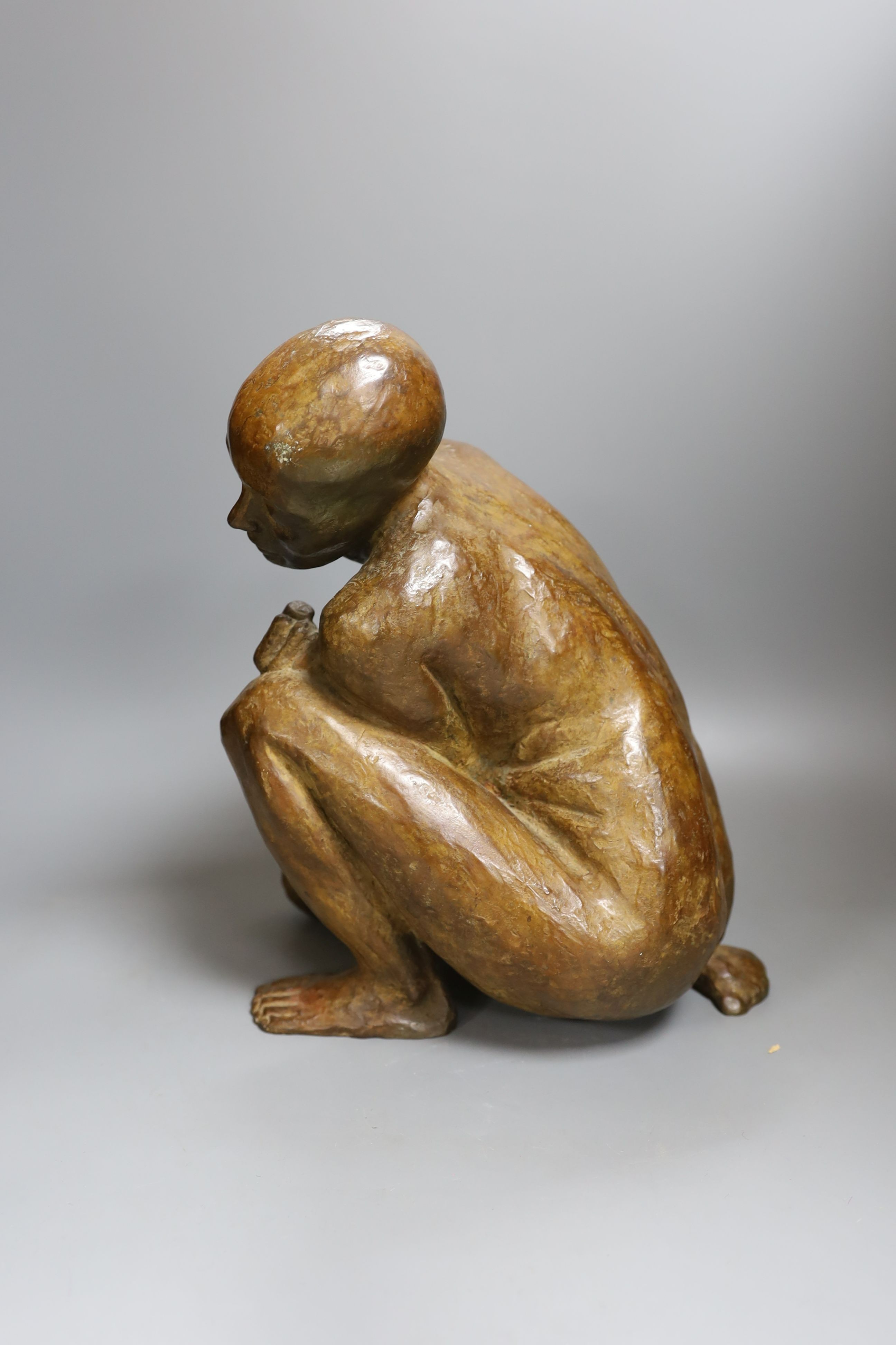 A contemporary bronze of a lady crouching with a thoughtful expression, unsigned - 31cm high